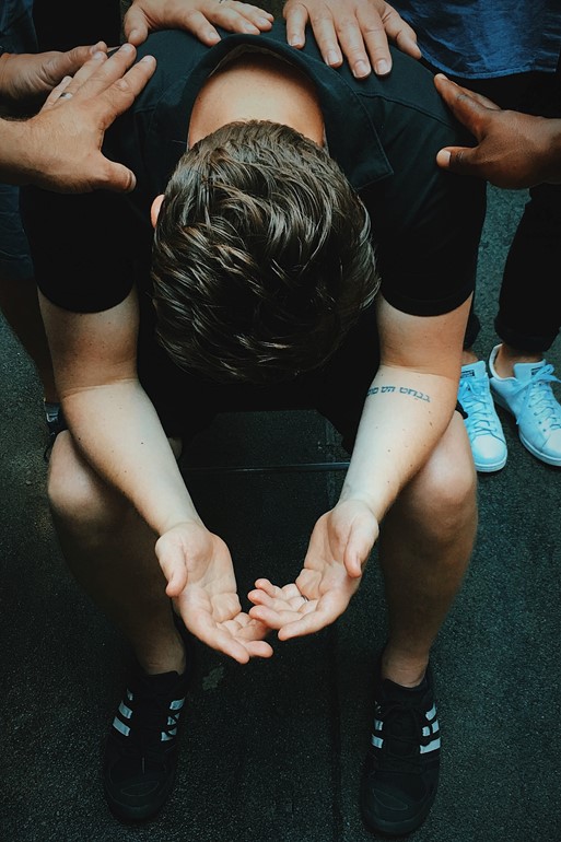 Young man with supportive hands on back