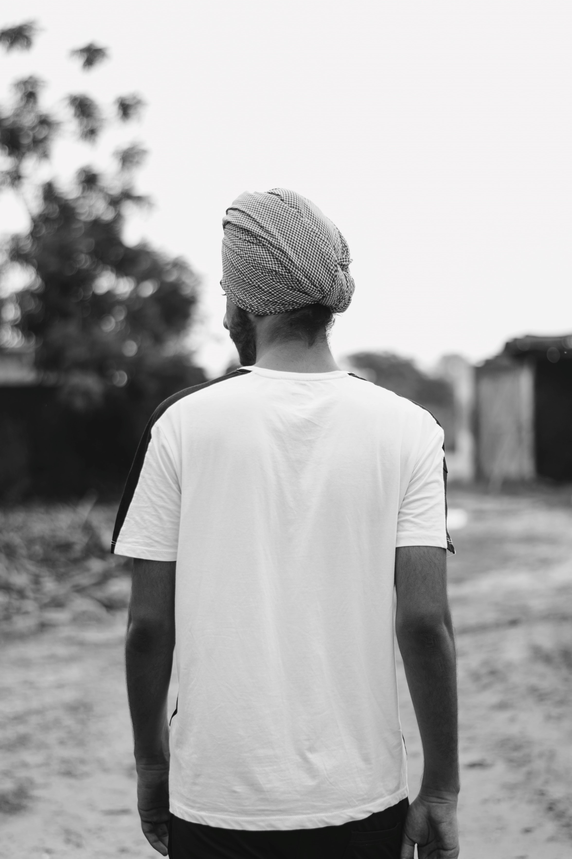 Sikh man in black and white facing away from camera